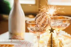 White bottle and champagne glasses with silver and with Christmas ball